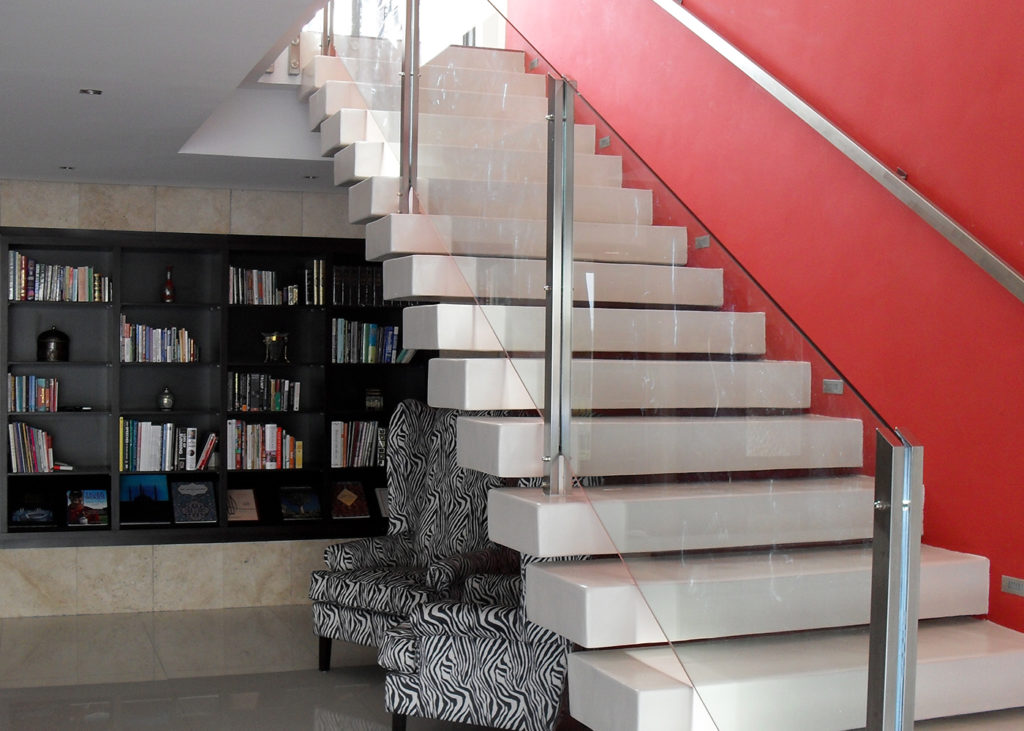 Frameless glass balustrade on a floating white staircase in a Cape Town home