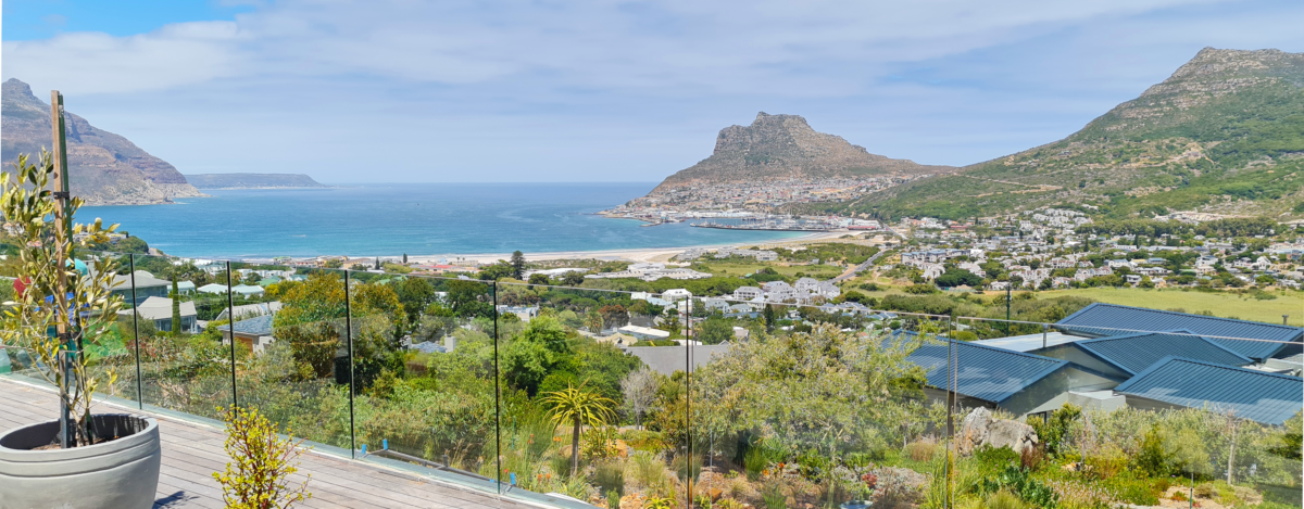 Frameless glass balcony balustrade on a timber deck overlooking Hout Bay, Cape Town